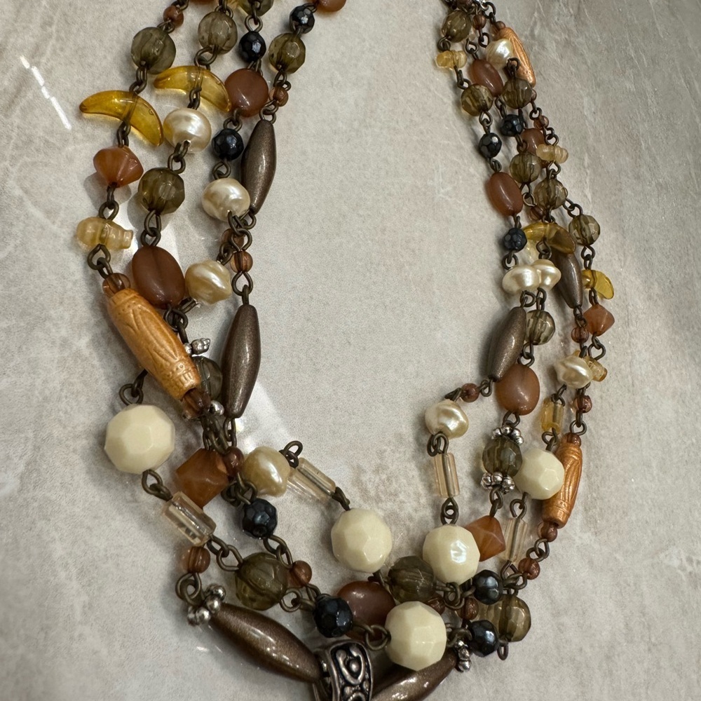 Multi-strand beaded necklace with a touch of brown and green hues. - Picture 2 of 7